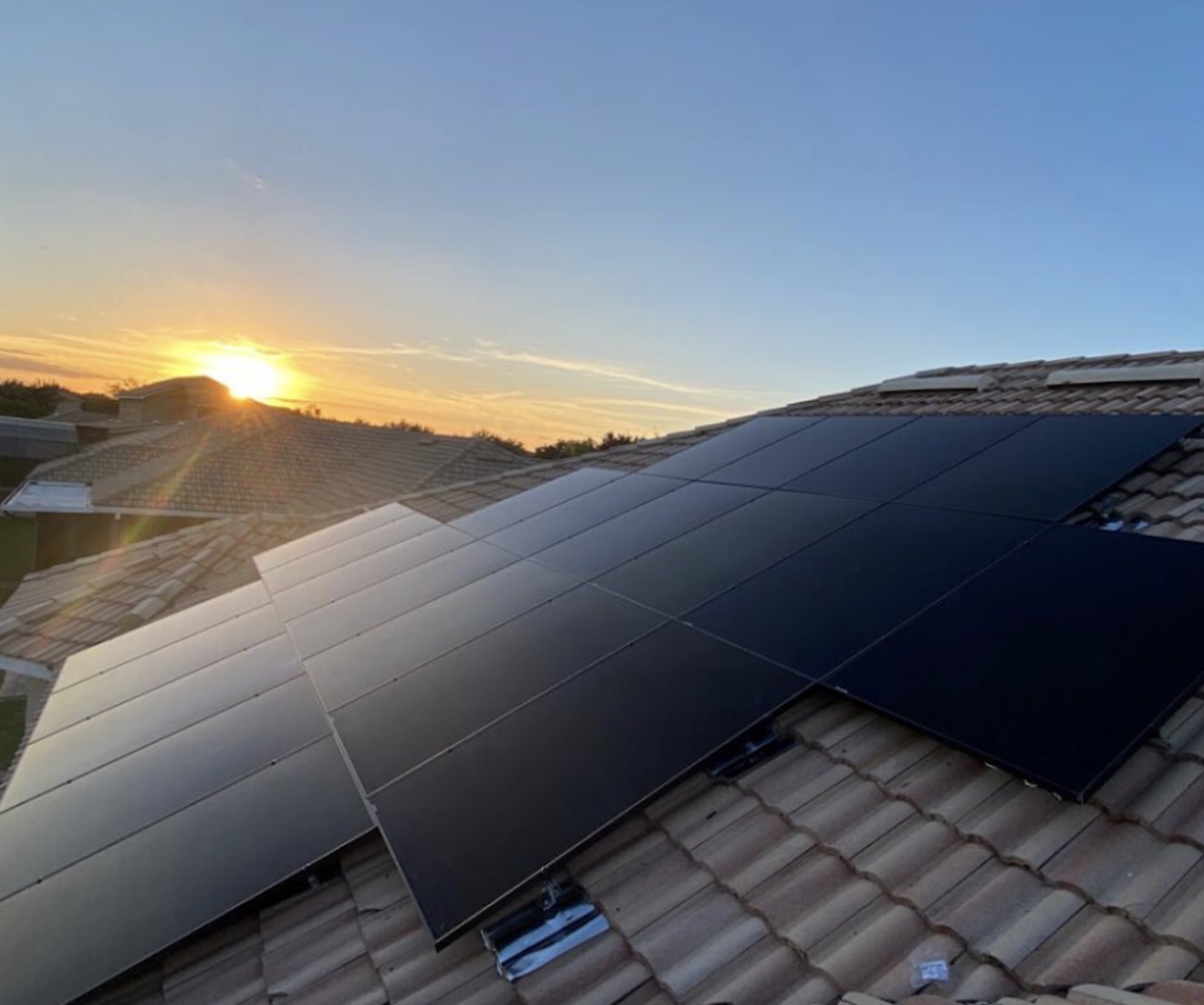 Solar array on a tile roof at sunset