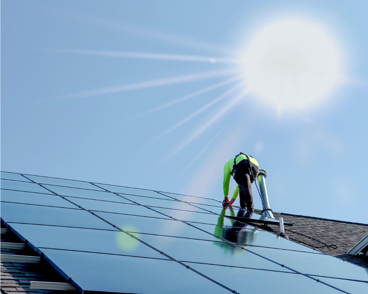 Installer working a solar array in direct sun